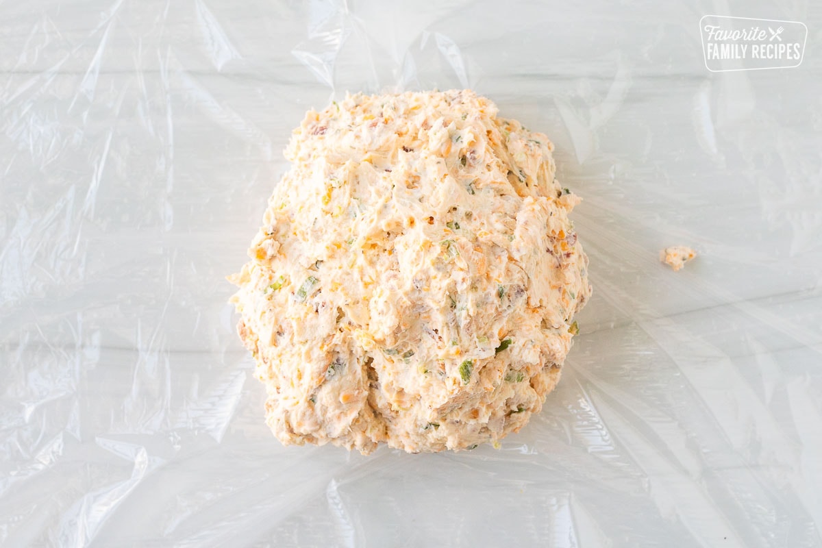 Cheese ball over plastic wrap.