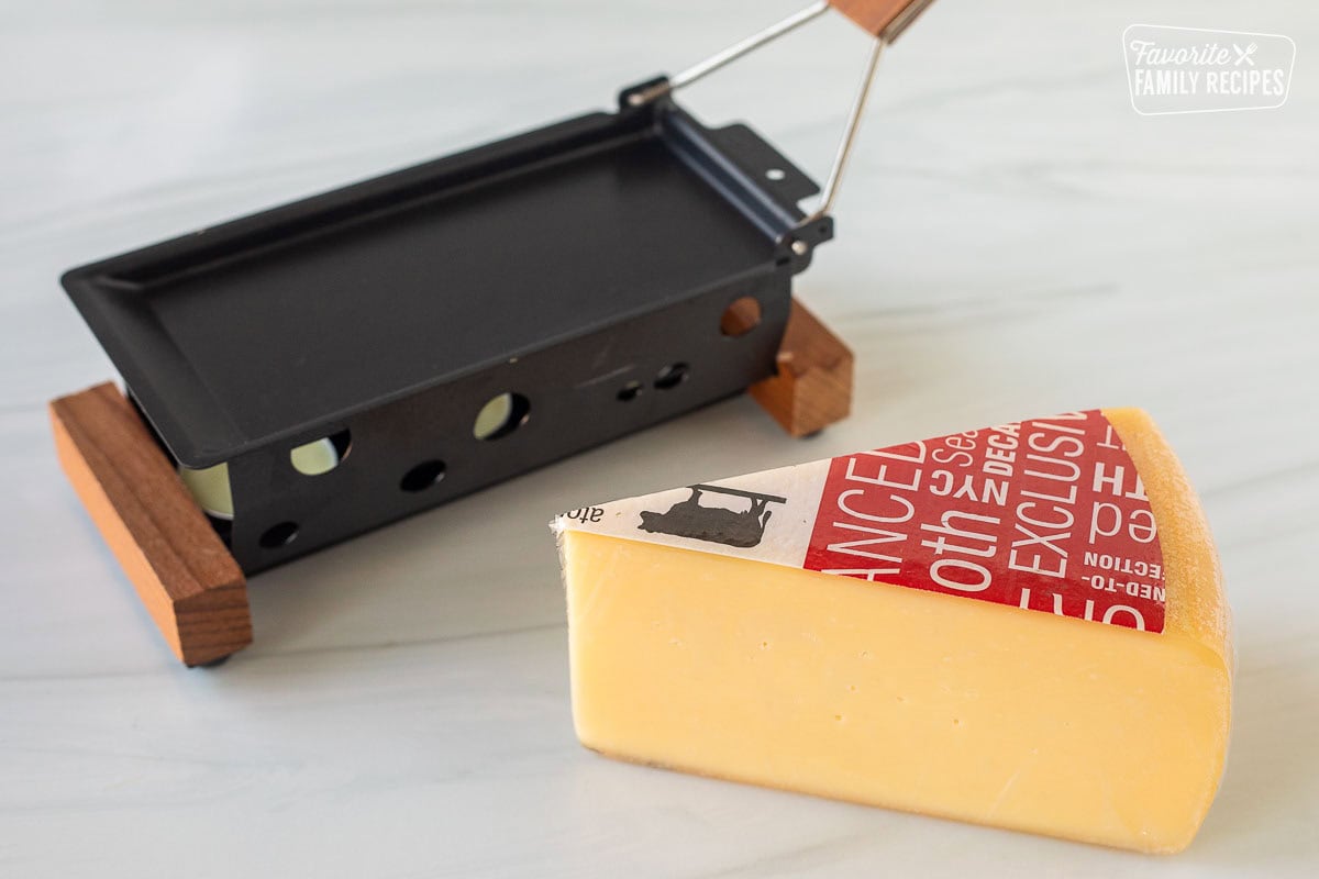 Raclette cheese wedge and a warmer.