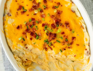 Scooped out Loaded Mashed Potatoes from a casserole dish.