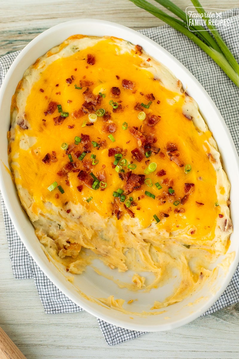 Scooped out Loaded Mashed Potatoes from a casserole dish.