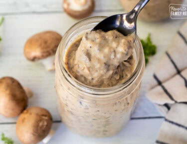 Spoonful of Condensed Cream of Mushroom Soup out of a jar.