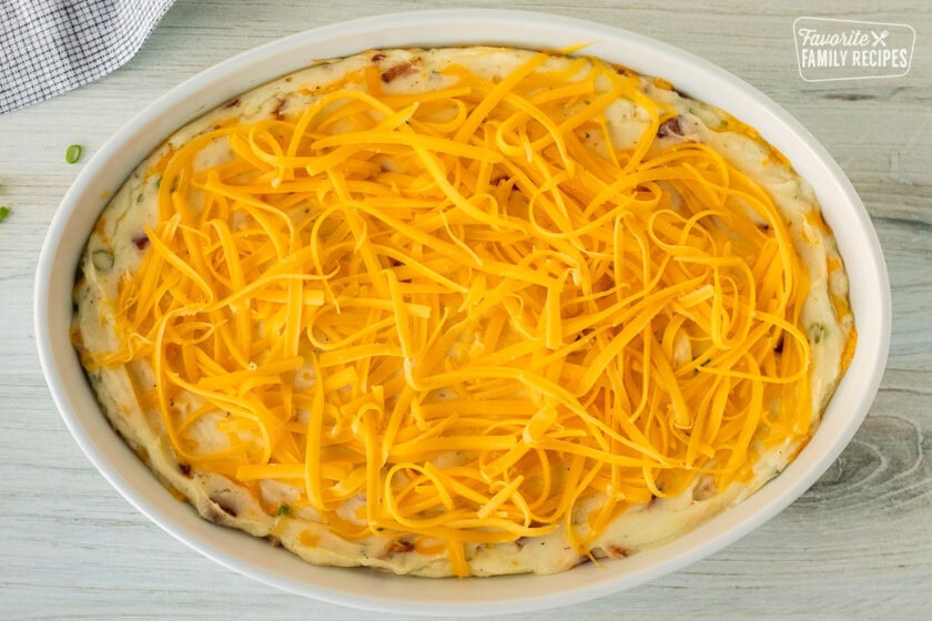 Shredded cheddar cheese on top of hot loaded mashed potato filling.