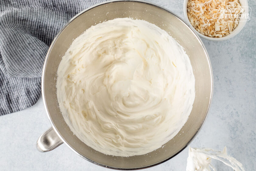 Mixing bowl with whipped cream. Whisk attachment on the side.