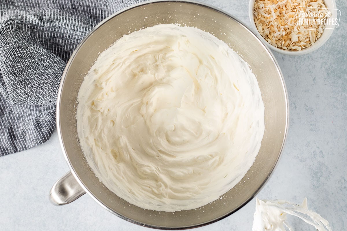 Mixing bowl with whipped cream. Whisk attachment on the side.