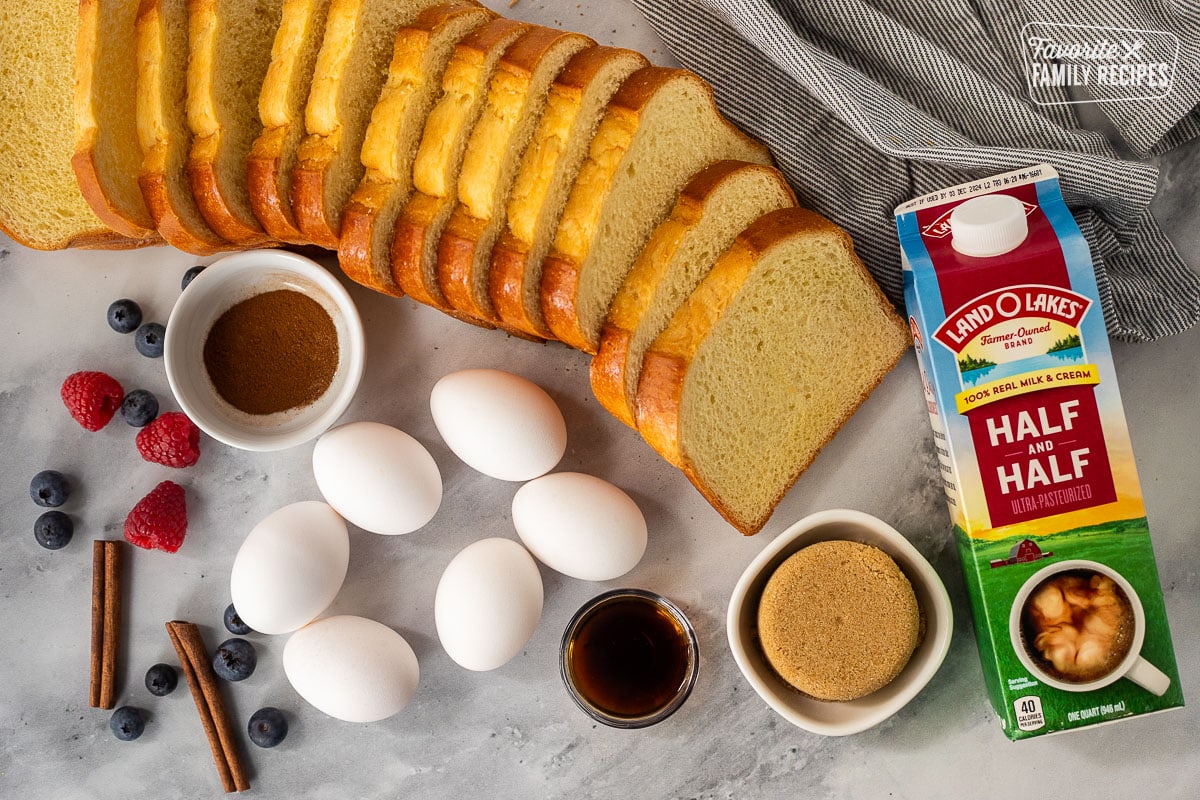 Ingredients to make brioche French toast casserole, including brioche bread, half-and-half, brown sugar, vanilla, eggs and apple pie spice.