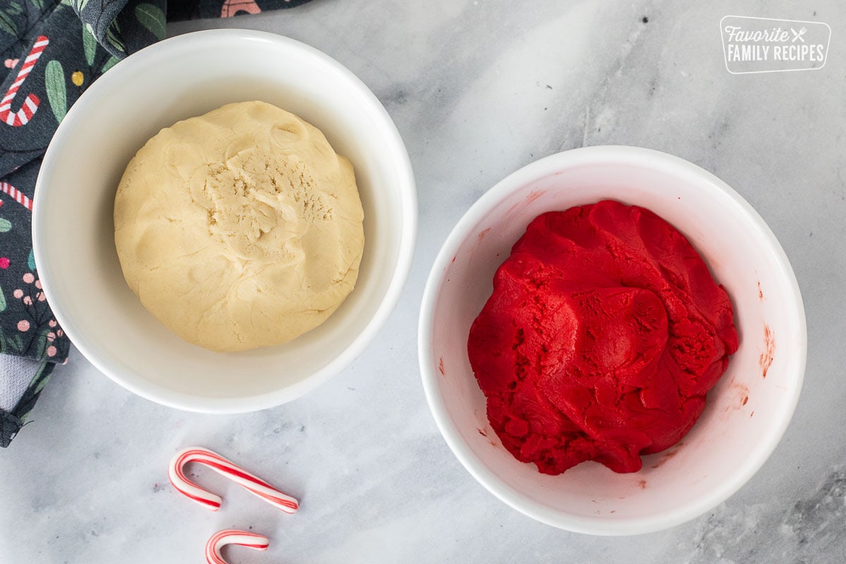 Two bowls of red and white cookie dough.