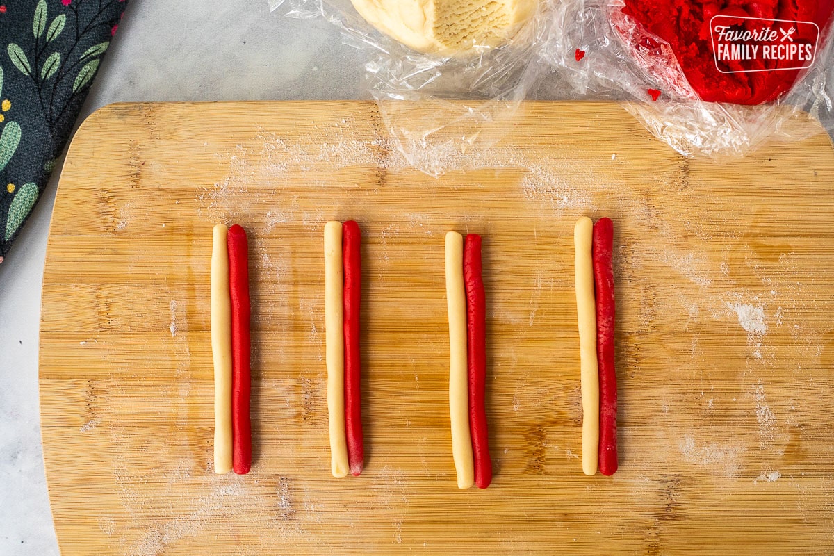 Red and white long rules of cookie dough, stuck side-by-side.