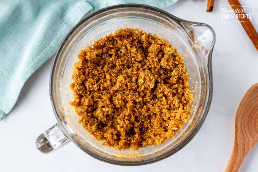 Glass bowl with cinnamon crumble mixture.