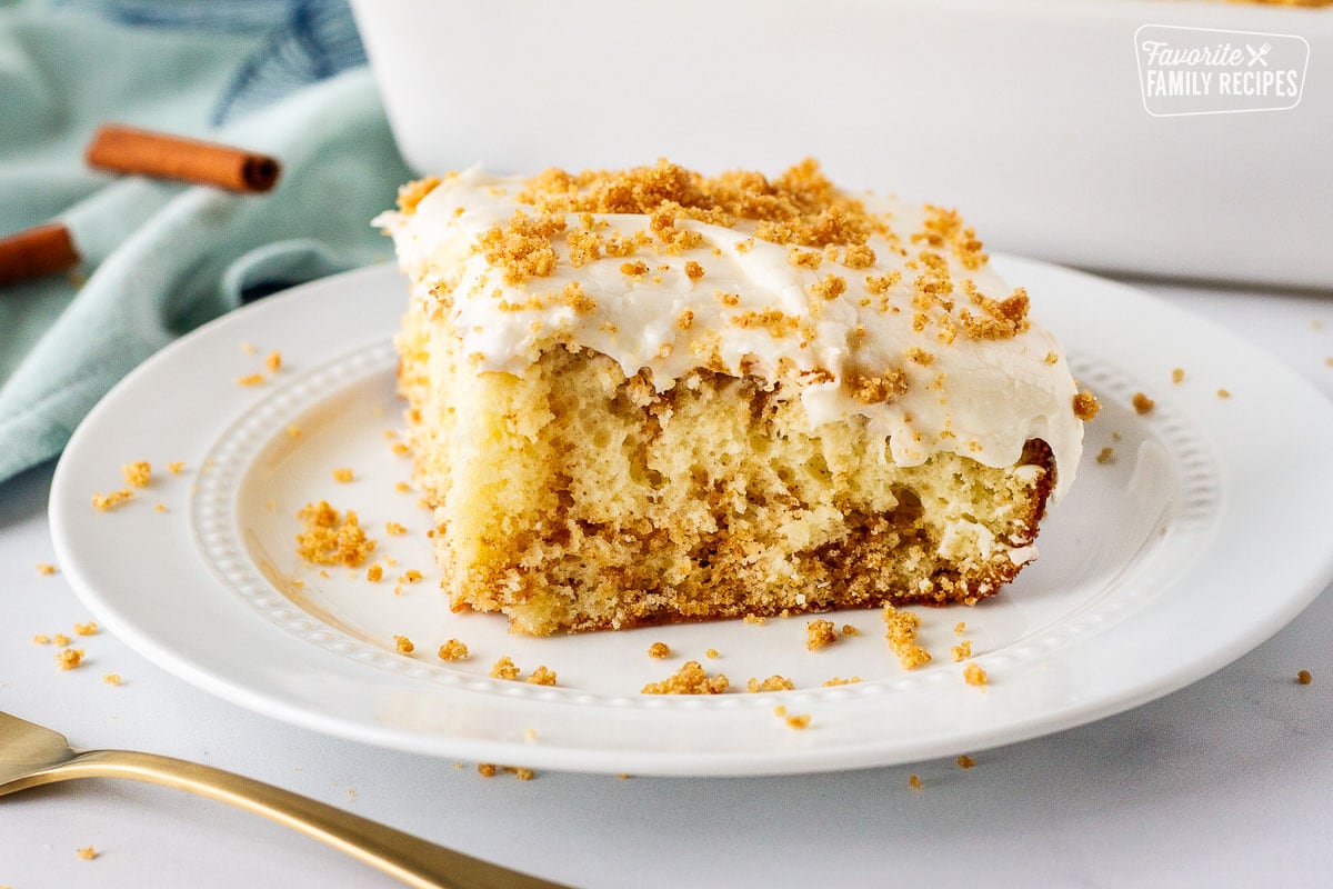 Slice of cinnamon roll cake on a plate.