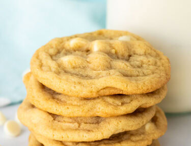 Stack of Vanilla Cookies next to a glass of milk.