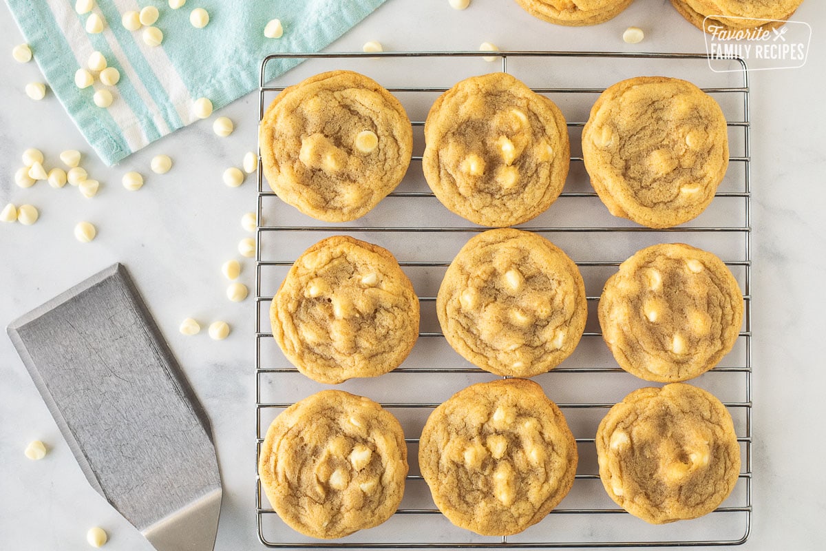 Baked Vanilla Cookies on a cooling rack next to a spatula.