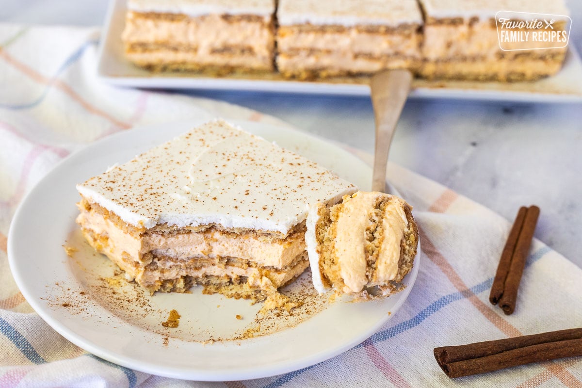 Slice of Pumpkin Eclair Cake with a fork cut into it.