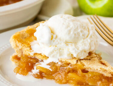 Close up of Homemade Apple Pie with melting vanilla ice cream.