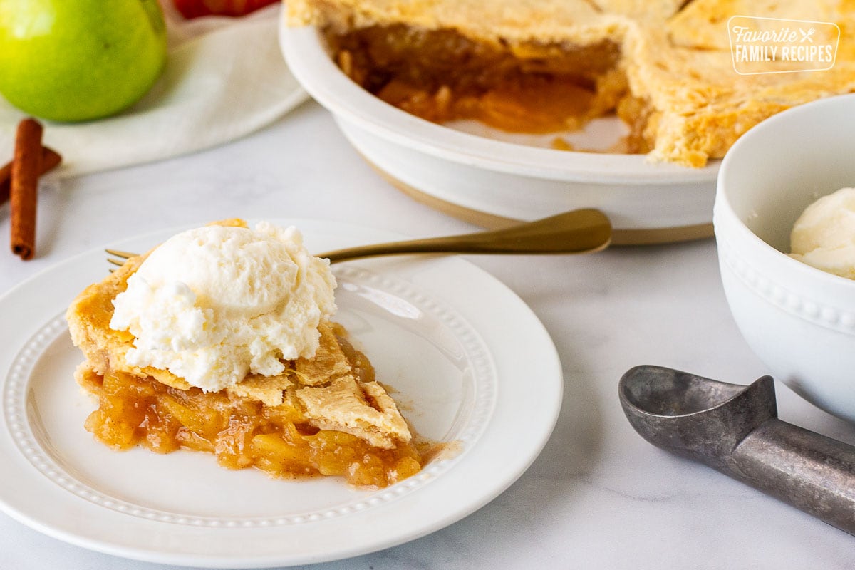 Plate of Homemade Apple Pie next to a bowl of vanilla ice cream.