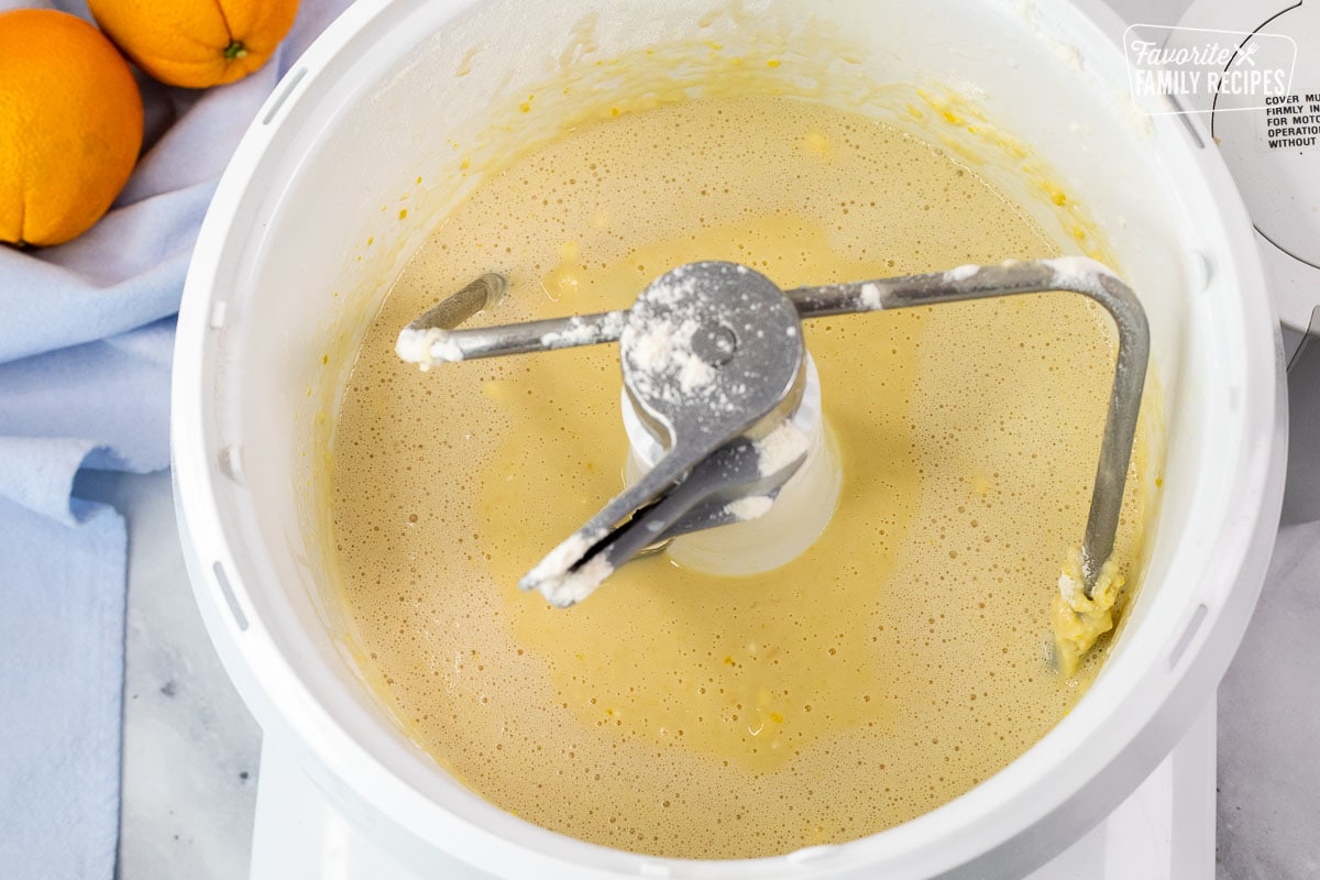 Electric bread dough mixer with yeast, milk, and flour mixture.