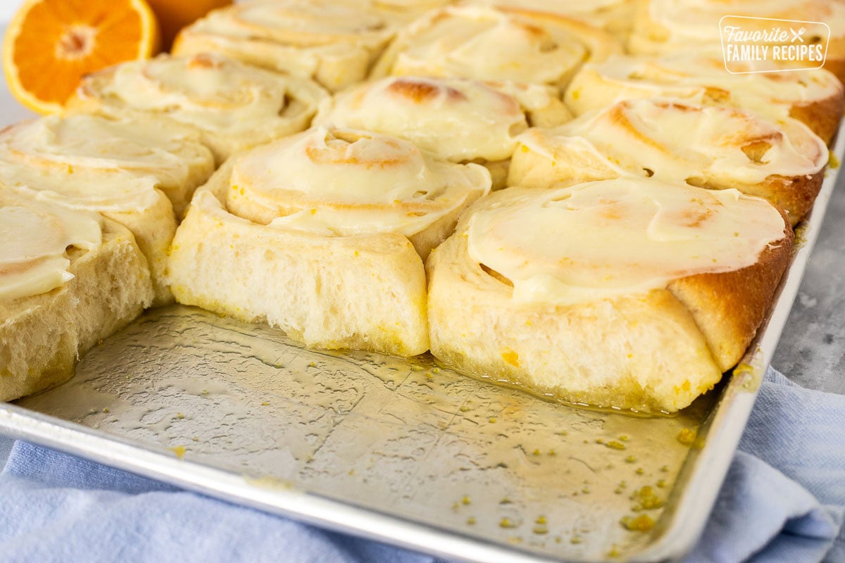 Baked orange rolls in a pan.