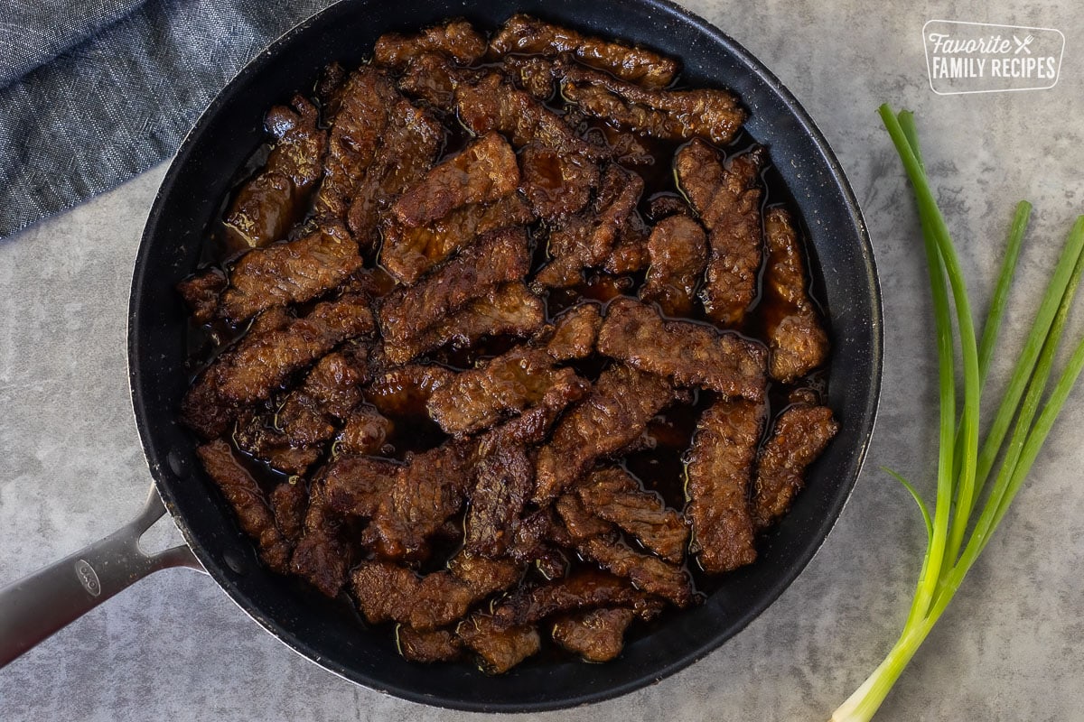 Mongolian beef in a skillet.