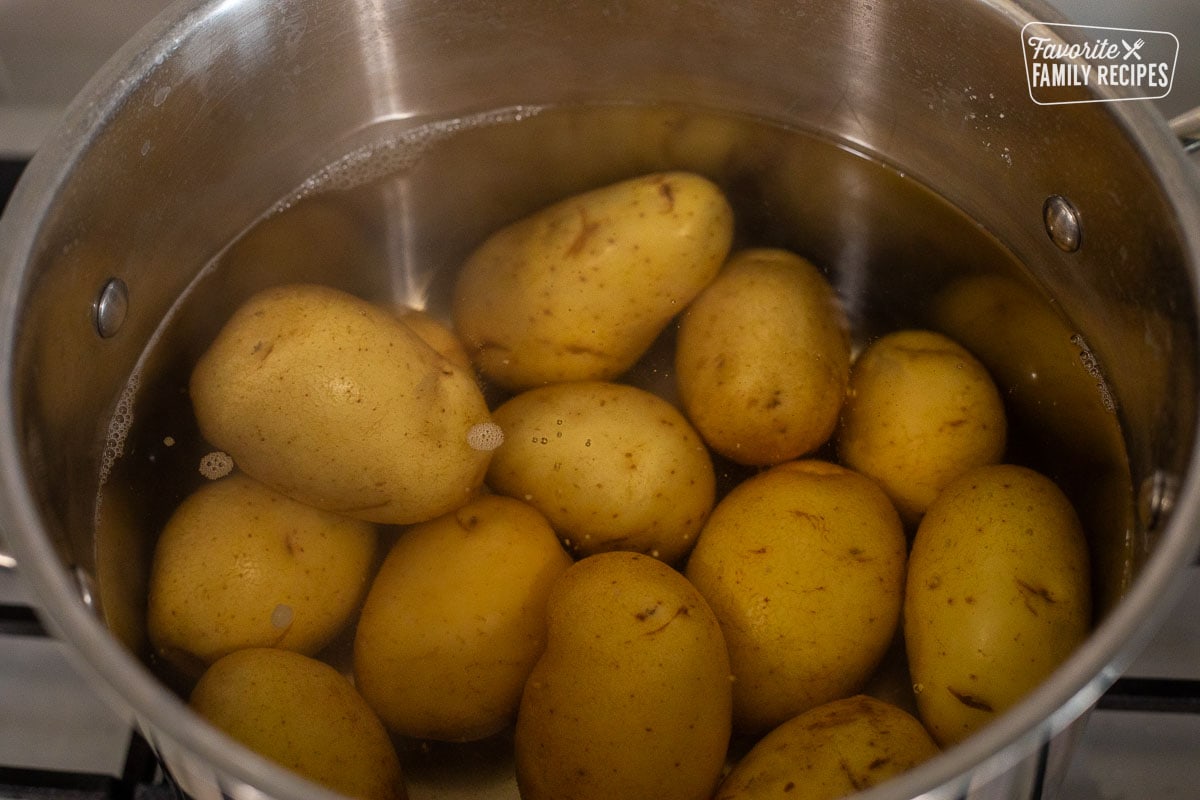 Boiling potatoes in a pot of water.