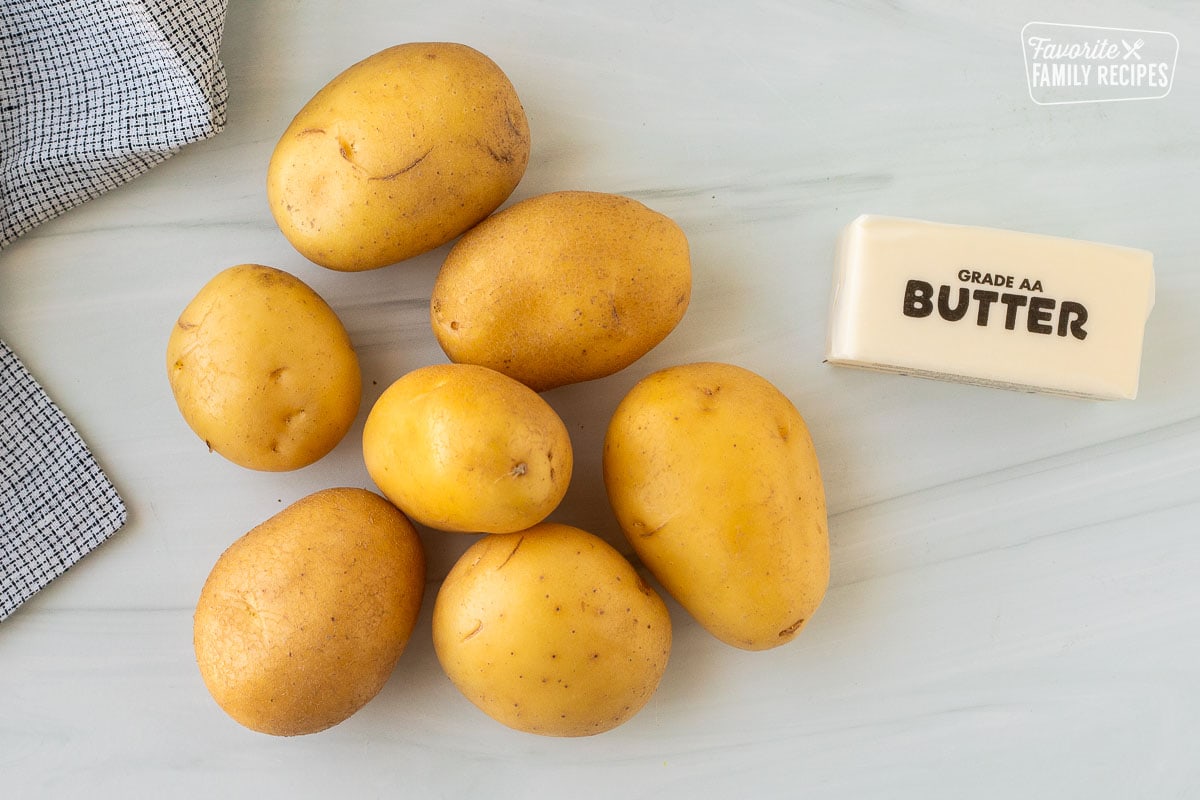 Ingredients to make Rosti including golden potatoes and butter.