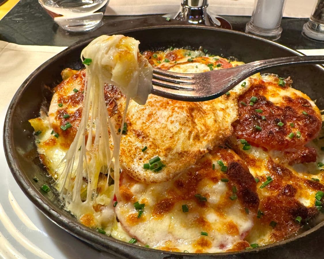 Rösti from a restaurant in Switzerland covered in cheese