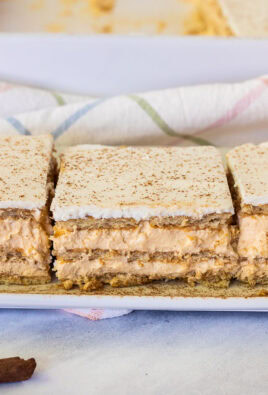 Three slices of Pumpkin Eclair Cake lined up on a plate.