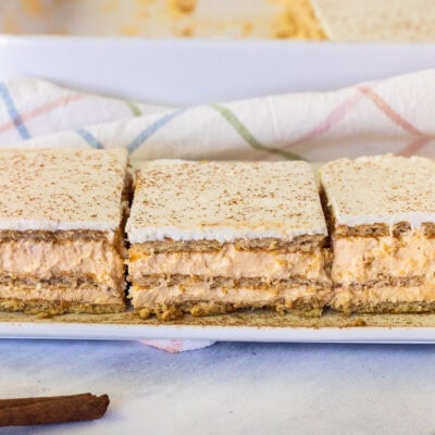 Three slices of Pumpkin Eclair Cake lined up on a plate.