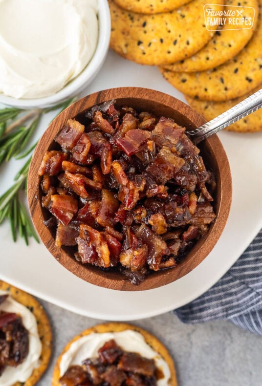 Bacon jam in a wooden bowl with a spoon.