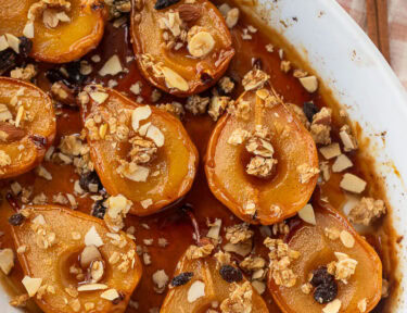 Baking dish of baked pears, topped with granola.