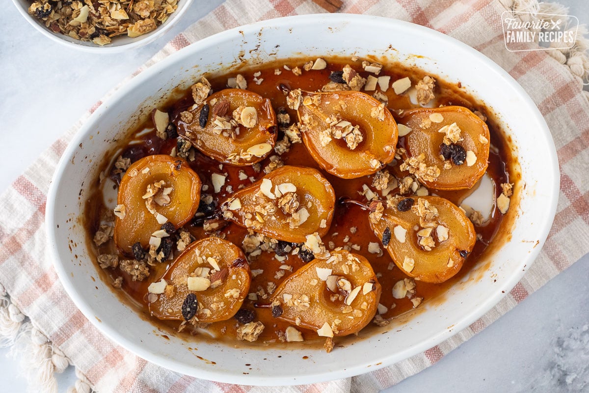 Baked pears in a baking dish topped with granola.