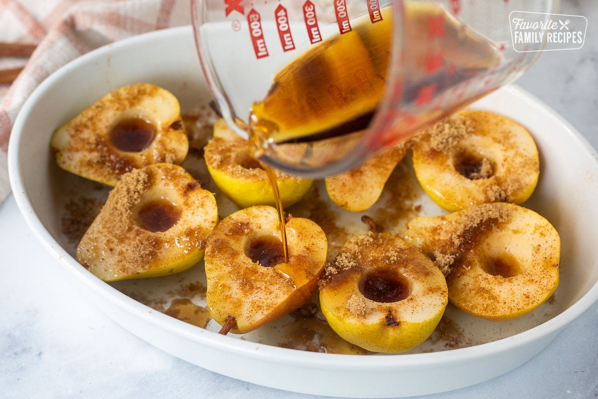 Pouring syrup mixture onto pears and a baking dish.