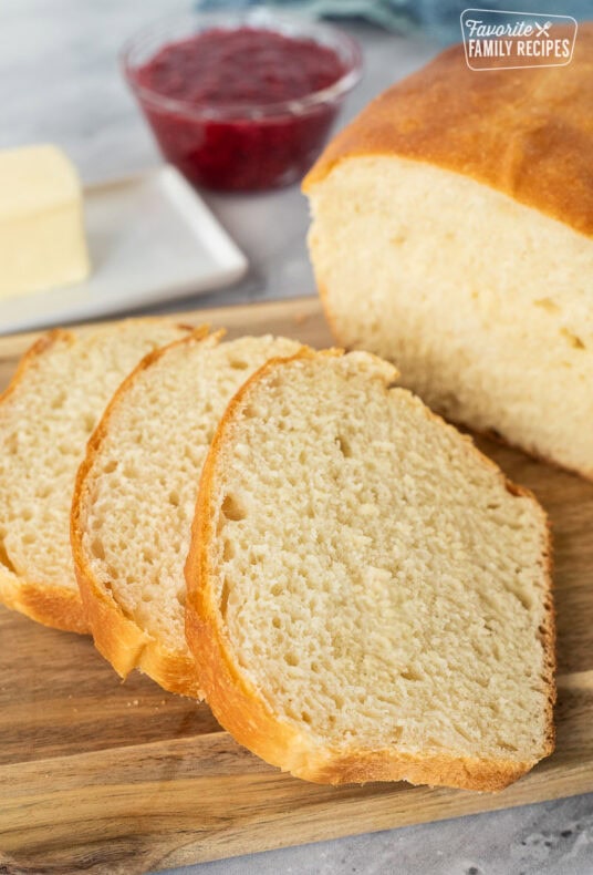 Sliced loaf of baked bread on a cutting board.