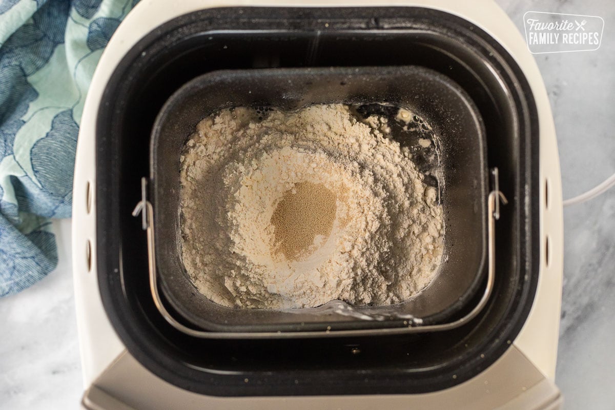 Bread machine with flour and yeast.