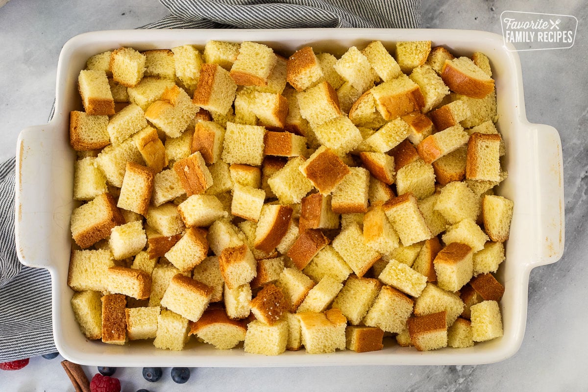 Baking dish with cut up brioche bread.