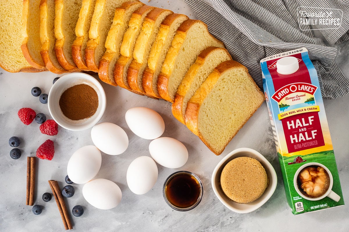 Ingredients to make brioche French toast casserole, including brioche bread, half-and-half, brown sugar, vanilla, eggs and apple pie spice.