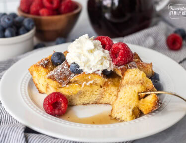 Brioche French toast casserole slice on a plate with a fork cut corner.