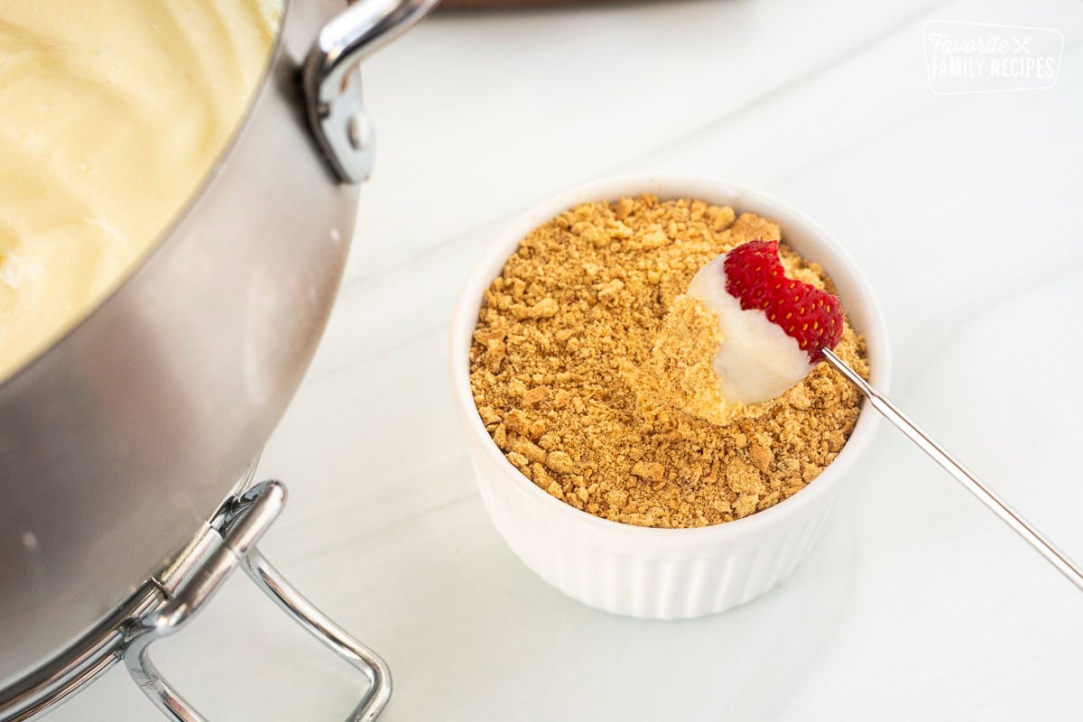 Strawberry dipped in cheesecake fondue and rolled in graham cracker crumbs.