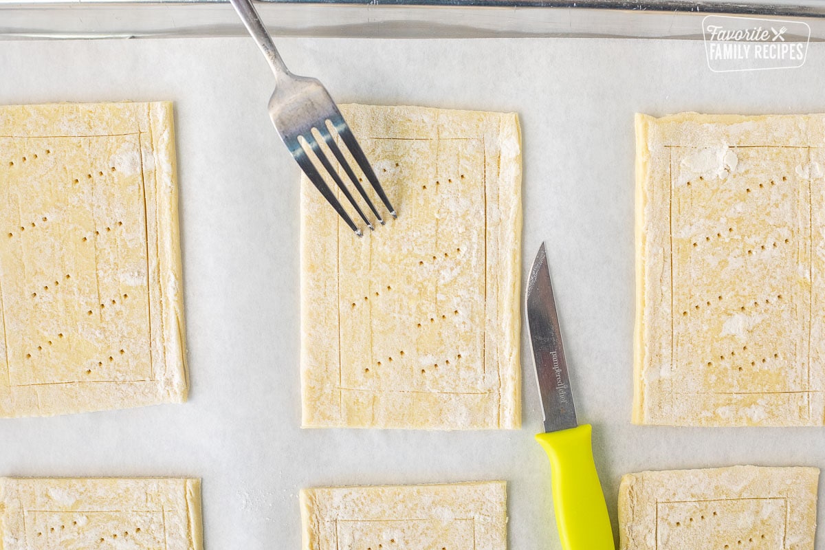 Puff pastry rectangle scored around the edge with a knife and poked with a fork in the center.