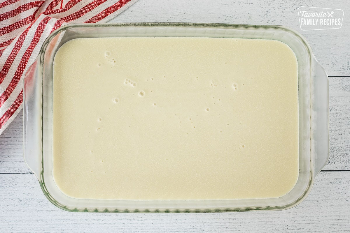 Glass baking dish with white Jell-O layer.