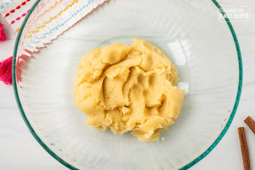 Glass mixing bowl with churro waffle base dough.