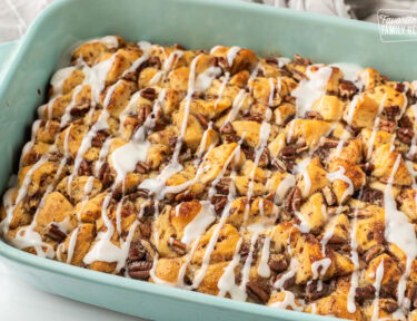 Baking dish of Cinnamon Roll Casserole with white icing on top.