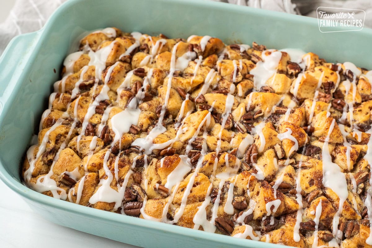 Baking dish of Cinnamon Roll Casserole with white icing on top.