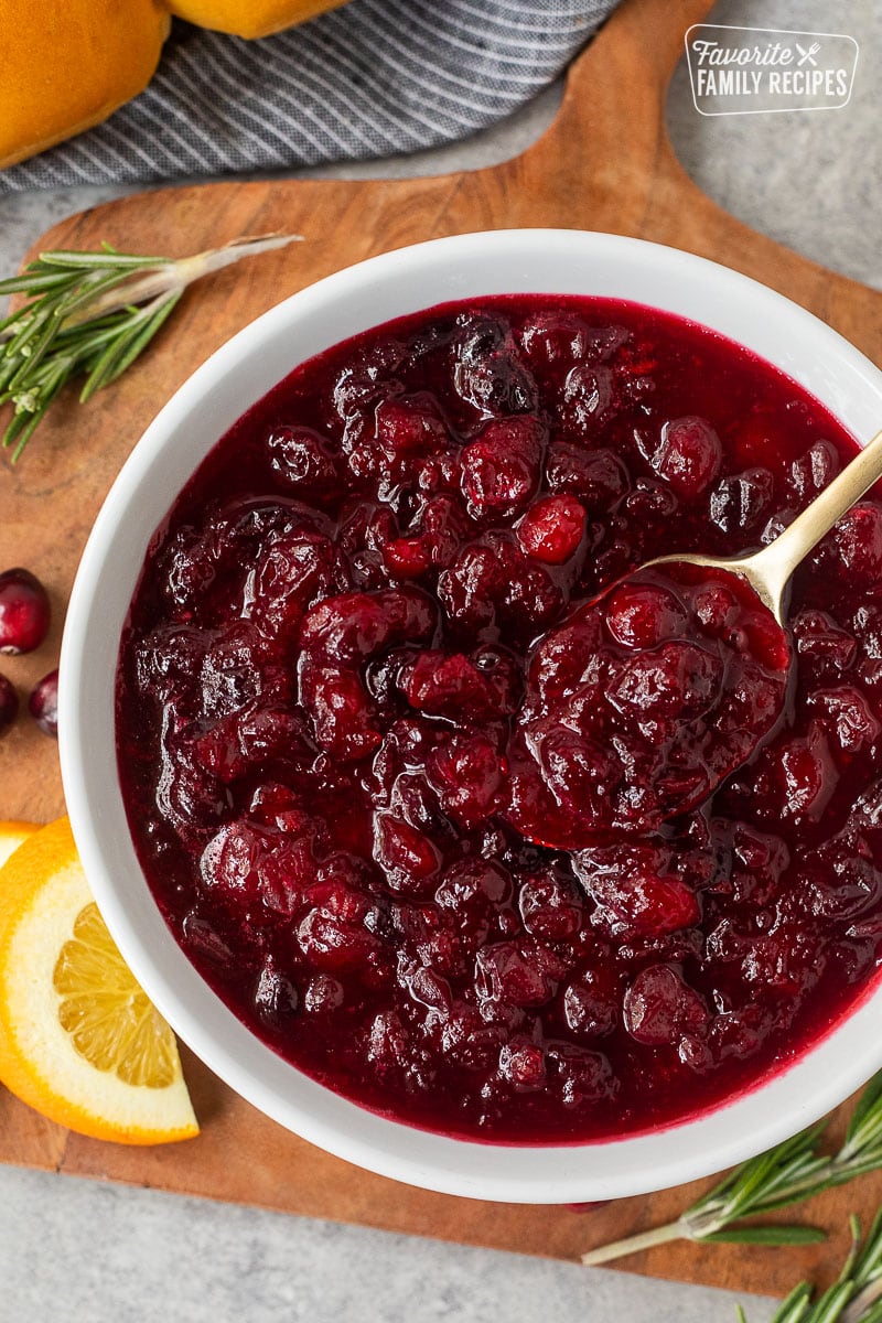 Fresh orange cranberry in a dish served with rolls on the side.