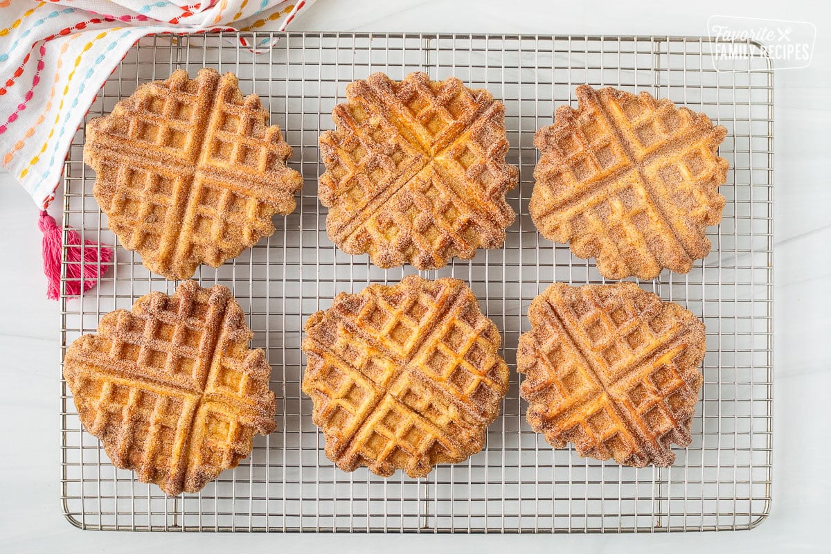 Cooling rack with six churro waffles.