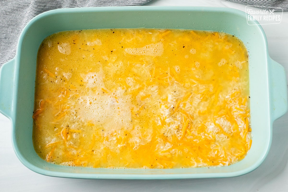 Baking dish with uncooked cheesy rice.