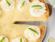 Slice of key lime pie being lifted from a whole southern key lime pie.