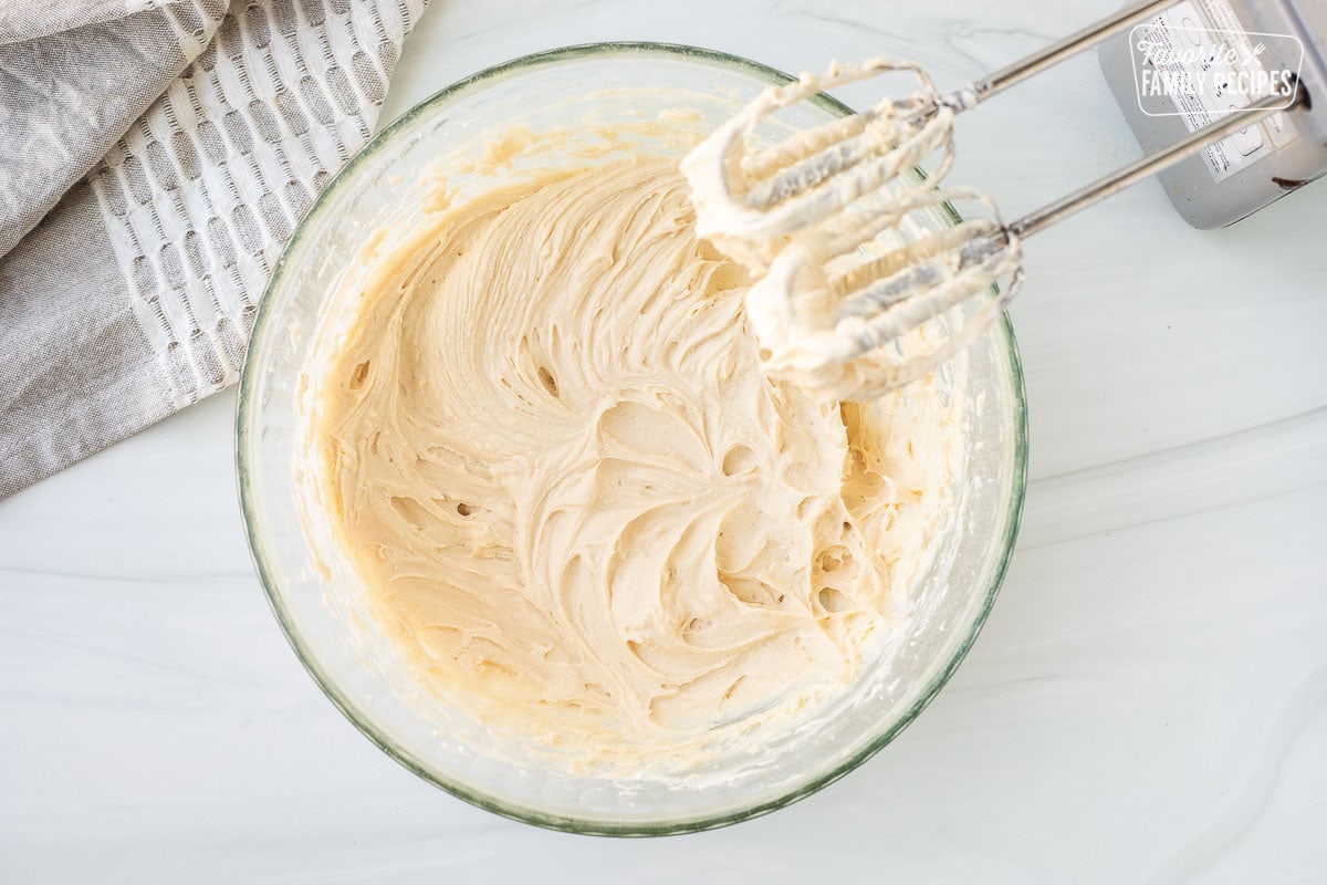 Mixing bowl with Chocolate Chip Cheese Ball base. Electric mixers on the side.