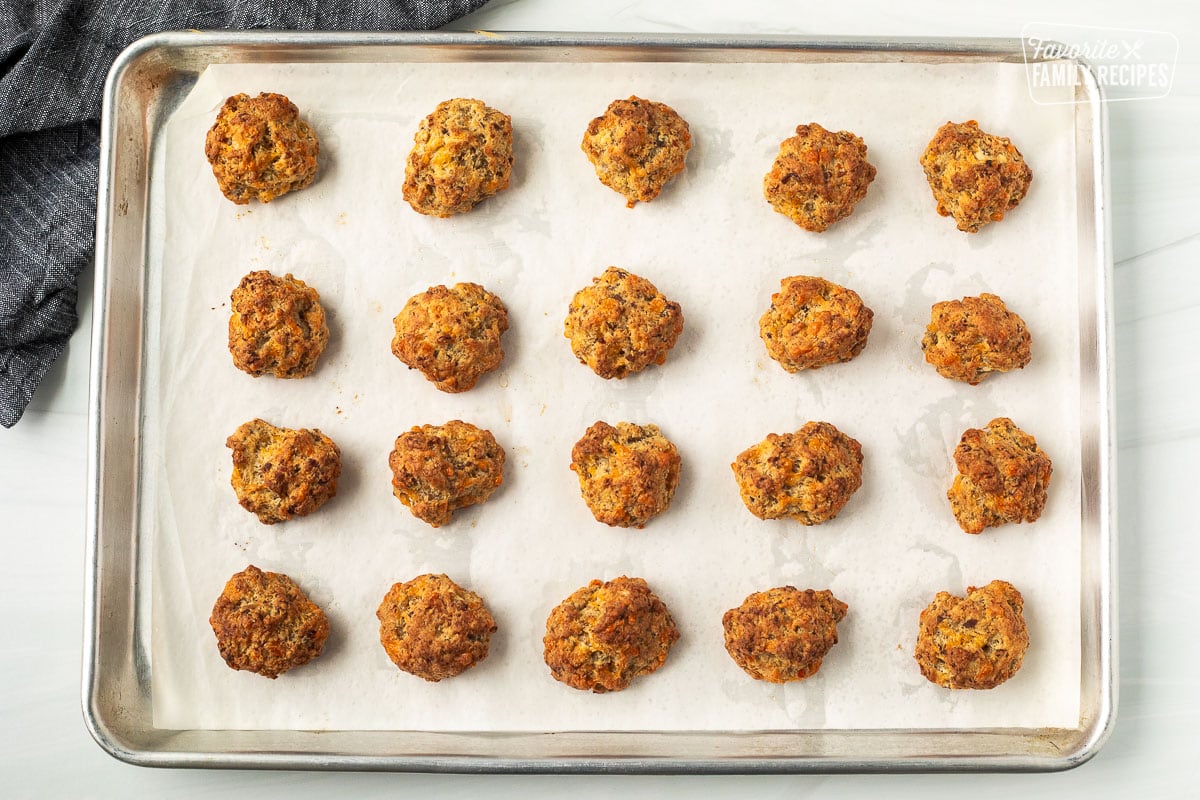 Baking sheet with baked Red Lobster sausage balls on a baking sheet lined with parchment paper.