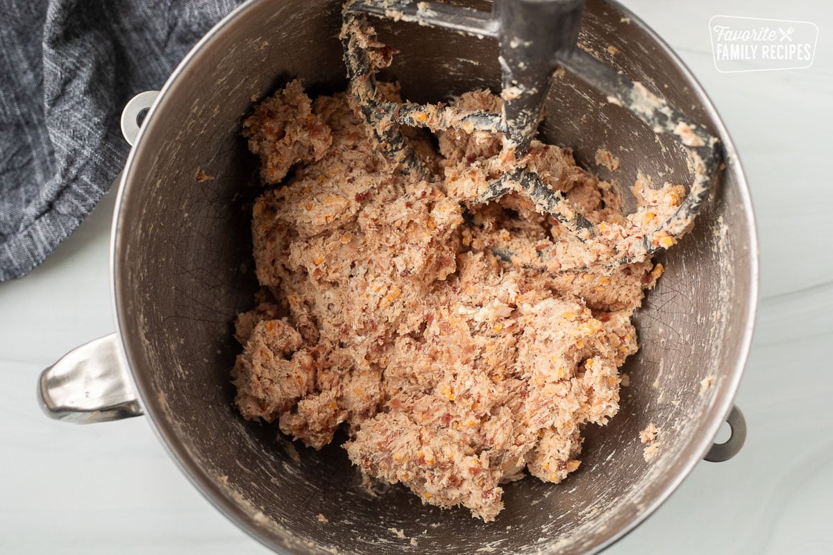 Mixing bowl with combined ingredients for biscuits. Paddle attachment resting the bowl.