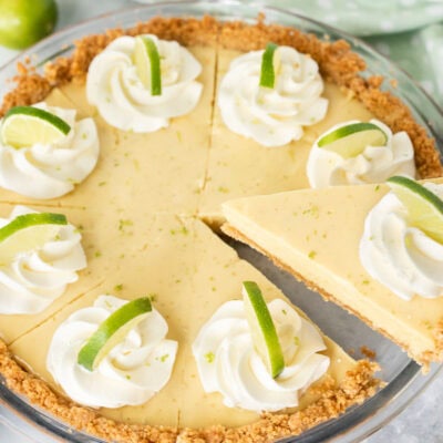 A slice of the best key lime pie being served with a pie server, southern recipe.