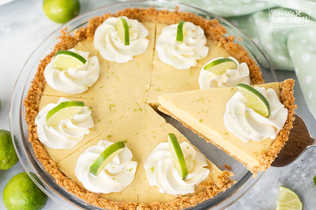 A slice of the best key lime pie being served with a pie server, southern recipe.